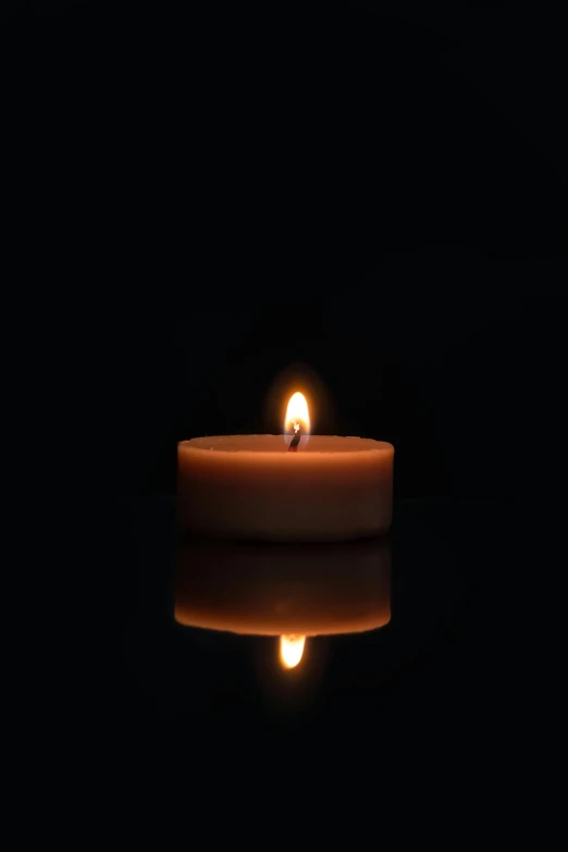 a single lit candle in the dark, by Nina Hamnett, minimalism, avatar image, reflection, photograph taken in 2 0 2 0, floating