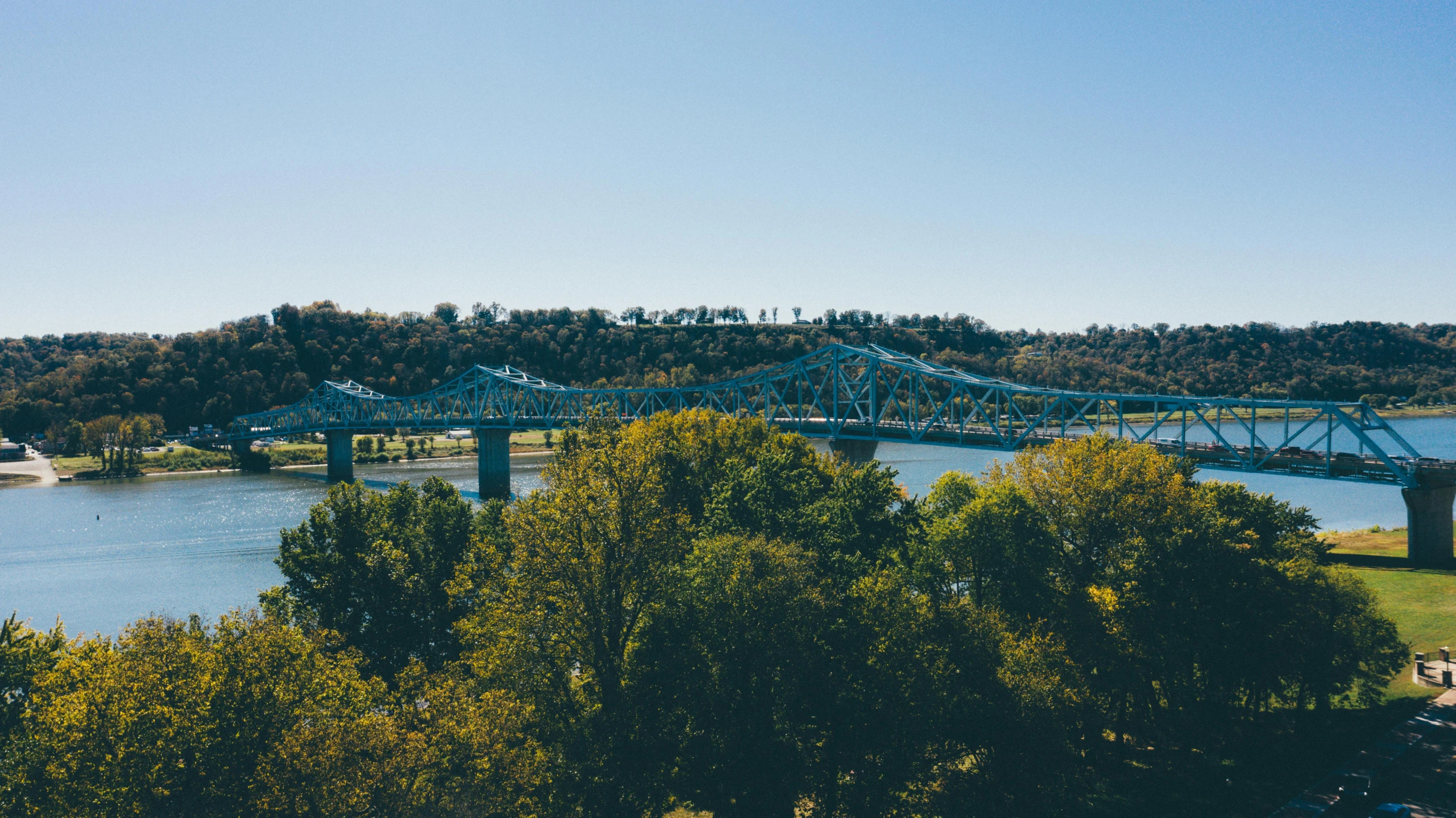 a view of a bridge over a body of water, by Winona Nelson, pexels contest winner, happening, memphis, picton blue, seen from far away, wide high angle view