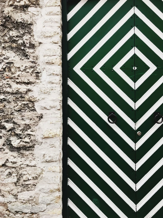 a green and white door in a stone building, an album cover, trending on unsplash, arts and crafts movement, hazard stripes, geometric wallpaper, trending on dezeen, 🚿🗝📝