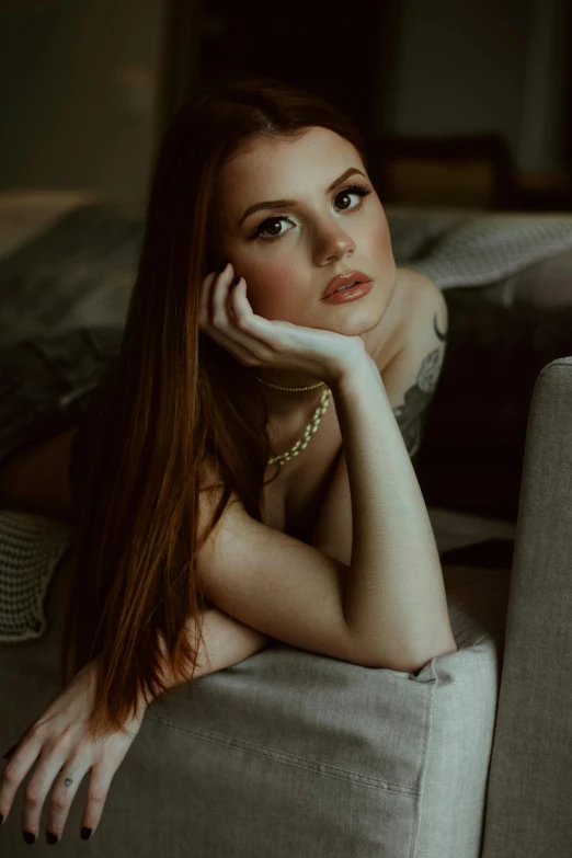 a beautiful young woman laying on top of a couch, a portrait, inspired by Elsa Bleda, trending on pexels, renaissance, ellie bamber, 🤤 girl portrait, brown haired, upscale photo