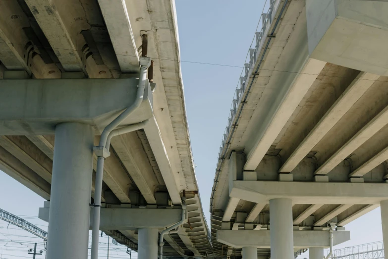 a couple of bridges that are next to each other, an album cover, by Carey Morris, unsplash, renaissance, steel pipes, highways, jr sc maglev, side view close up of a gaunt