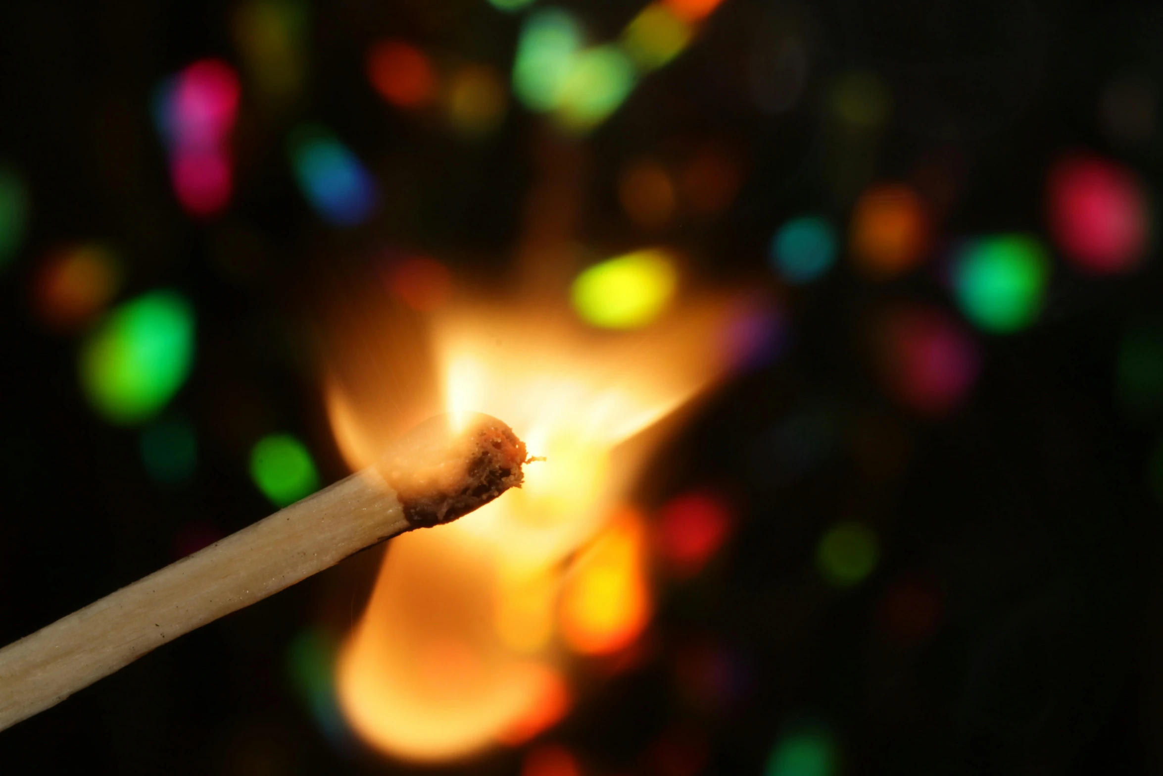 a close up of a matchstick with colored lights in the background, pexels, happening, tiny firespitter, instagram post, starburst, photographed for reuters
