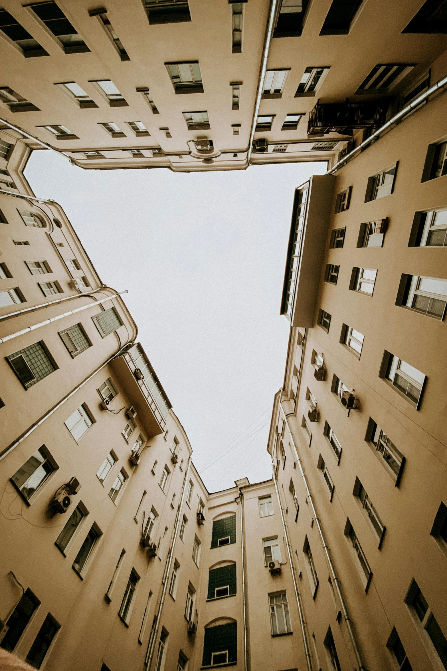a very tall building with lots of windows, inspired by Alexander Rodchenko, unsplash contest winner, neoclassicism, naples, alleys, worm\'s eye view, panoramic photography