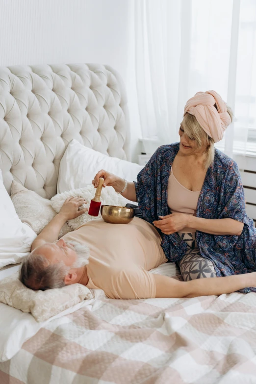 a man laying on top of a bed next to a woman, pexels contest winner, renaissance, holding a bell, kundalini energy, old man, profile image