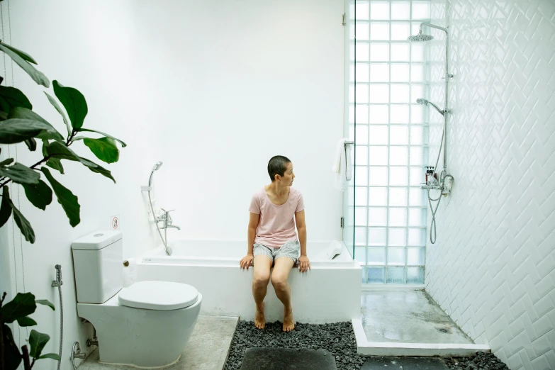 a man sitting on a bathtub in a bathroom, inspired by Ruth Jên, pexels contest winner, minimalism, young asian girl, genderless, wide full body, compassionate