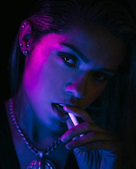 a woman smoking a cigarette in a dark room, an album cover, inspired by Elsa Bleda, trending on pexels, neon coloring, madison beer girl portrait, non binary model, in a cyber - punk ally