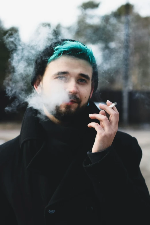 a man with green hair smoking a cigarette, inspired by Elsa Bleda, trending on pexels, renaissance, discord profile picture, young male, scruffy man, ethan klein