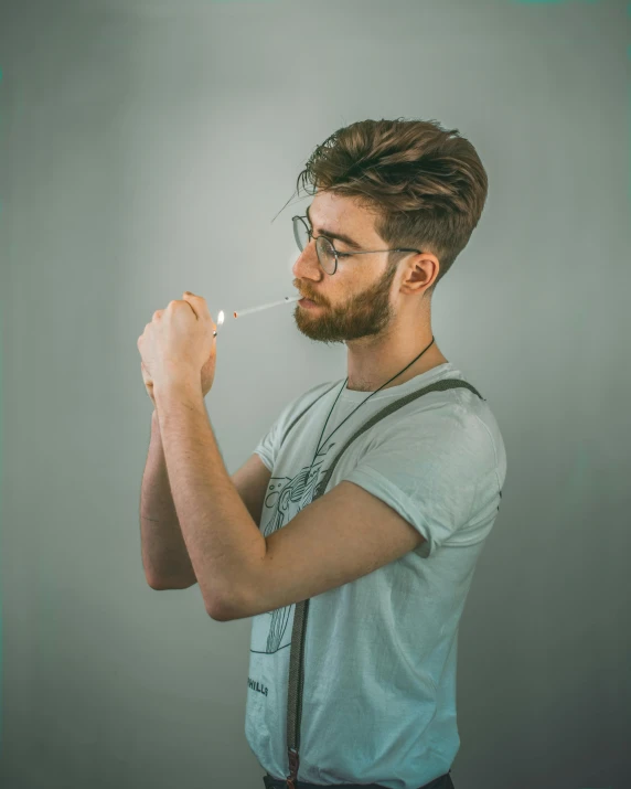 a man brushing his teeth with a toothbrush, a colorized photo, by Adam Dario Keel, trending on pexels, renaissance, drinking whiskey, lgbt, wearing square glasses, profile image