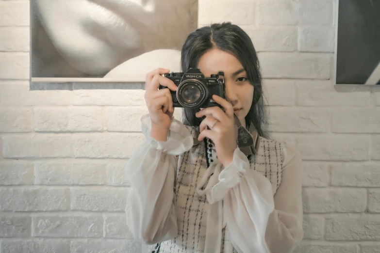 a woman taking a picture of herself with a camera, a picture, pexels contest winner, wearing a blouse, lovingly looking at camera, indoor picture, stylish pose