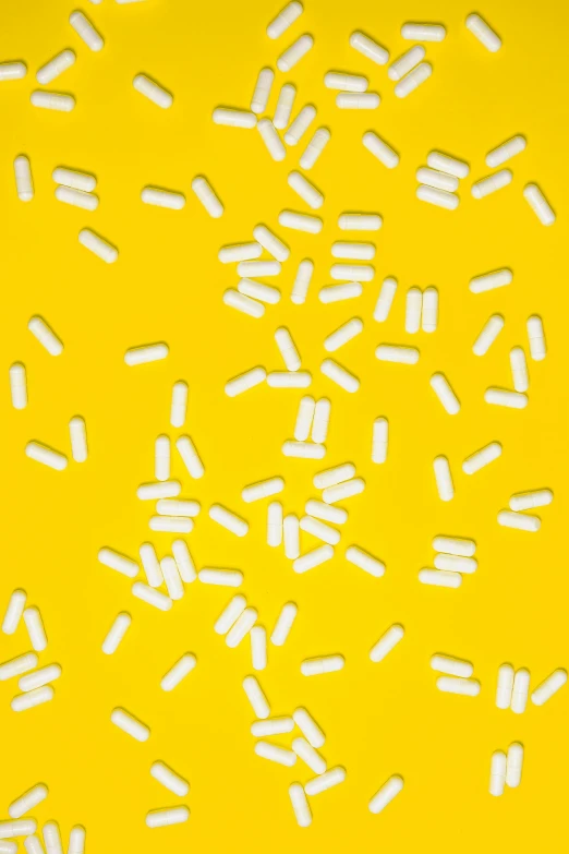 white sprinkles on a yellow background, unsplash, plasticien, taking mind altering drugs, charts, 2010s, larvae
