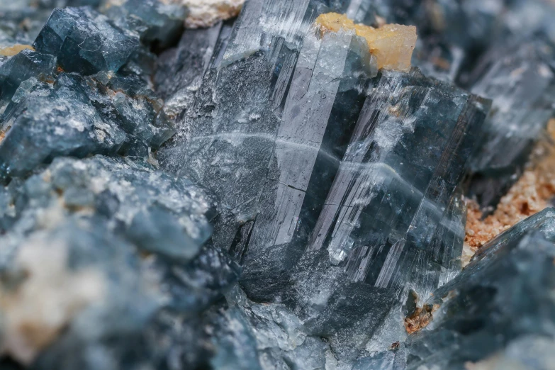 a piece of rock sitting on top of a pile of rocks, a microscopic photo, unsplash, crystal cubism, blue gray, high detailed thin stalagtites, ((rocks)), thumbnail