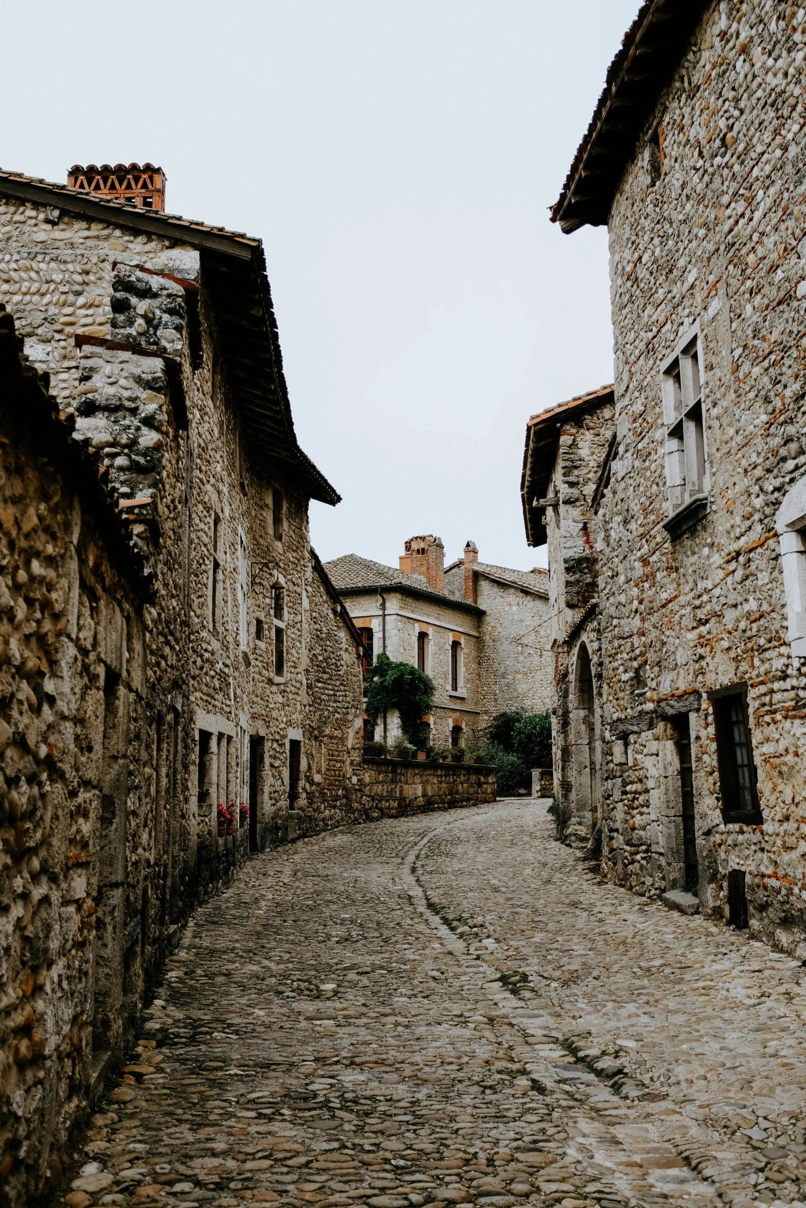 a cobblestone street lined with stone buildings, pexels contest winner, romanesque, french village interior, sleepy, top down photo, thin