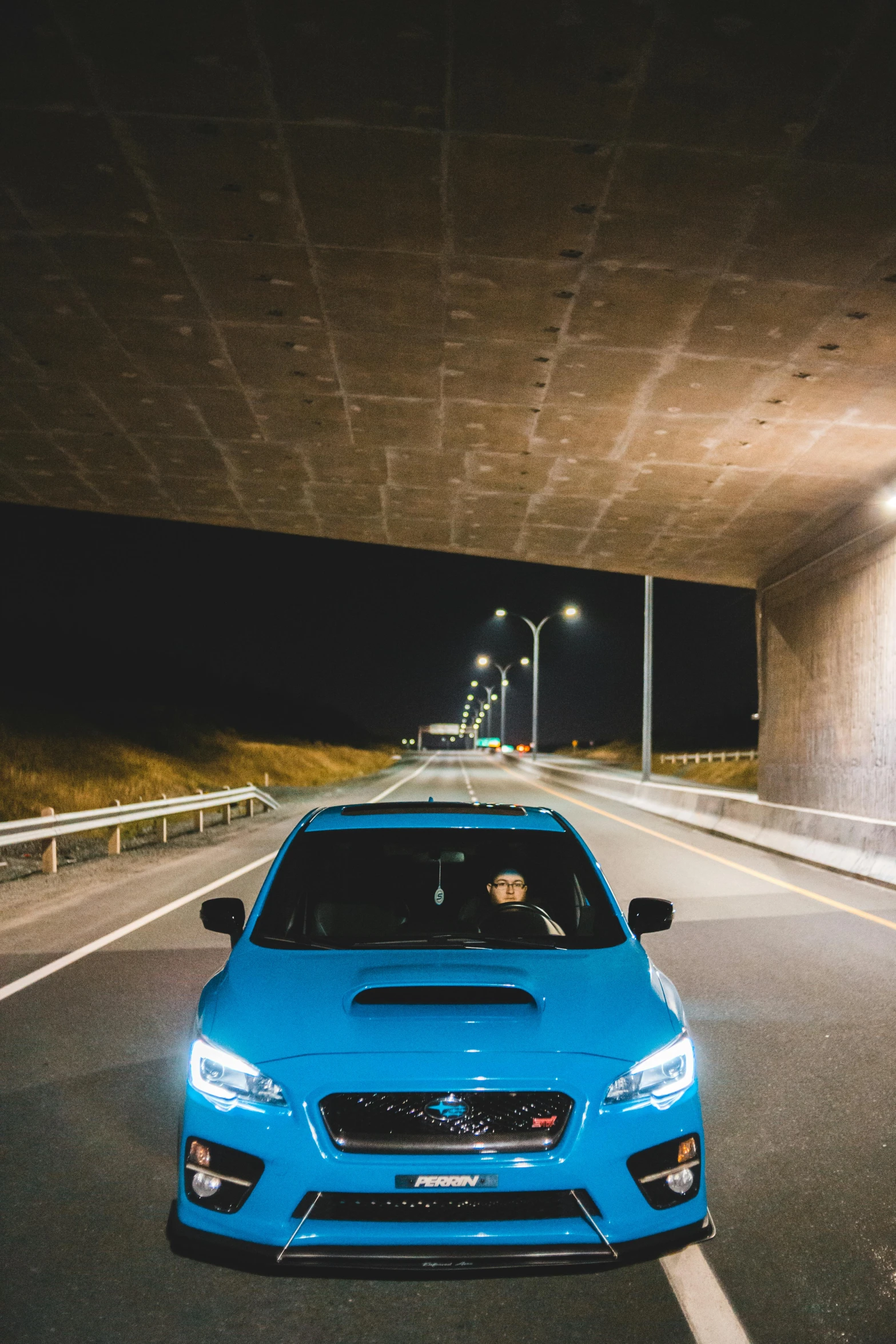 a blue car driving under a bridge at night, unsplash contest winner, subaru, portrait photo, square, wrx golf