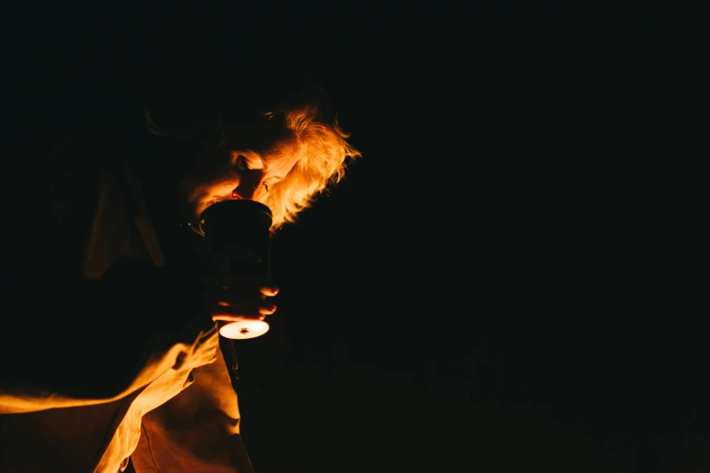 a man holding a flashlight in the dark, pexels contest winner, drinking a beer, the sorceress casting a fireball, low angle photo, high resolution photo