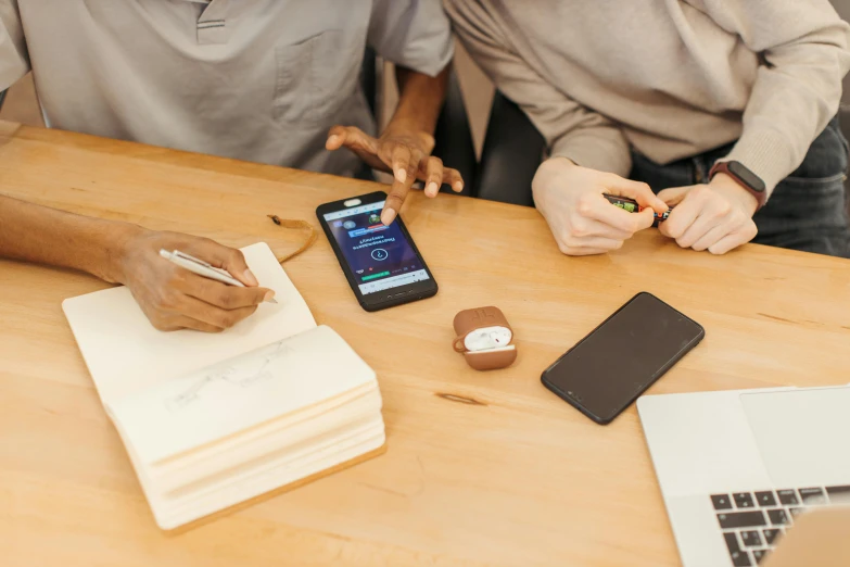 a couple of people that are sitting at a table, a picture, trending on pexels, samsung smartthings, a wooden, corporate phone app icon, designer product