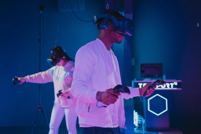 a couple of men standing next to each other on a stage, a hologram, pexels, interactive art, twins playing video games, 3 d goggles, brightly lit blue room, avatar image