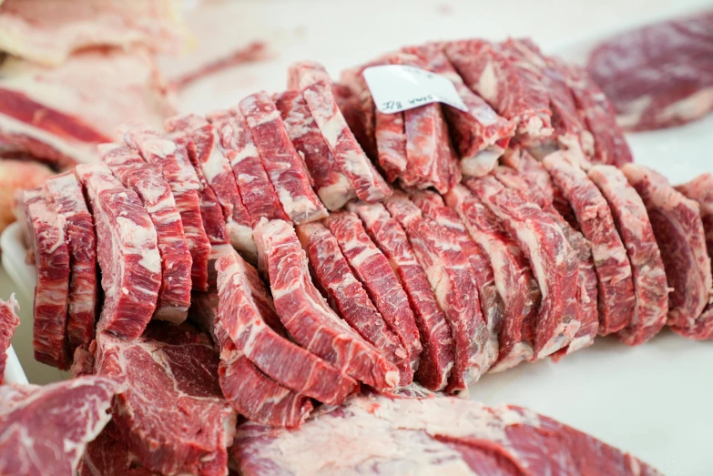 a pile of meat sitting on top of a cutting board, close to the camera, 🦩🪐🐞👩🏻🦳, chiseled features, rows of razor sharp teeth