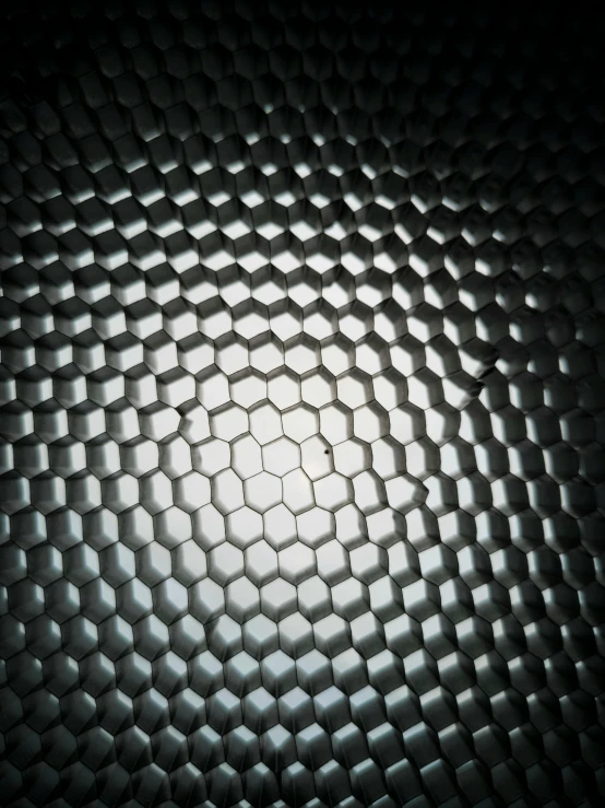 a black and white photo of a hexagonal pattern, an album cover, unsplash contest winner, translucent sphere, carbon fiber, shiny textured plastic shell, glowing internal light