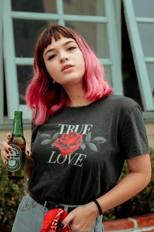 a woman with pink hair holding a beer, by Robbie Trevino, true love, wearing a black tshirt, roses, official product photo