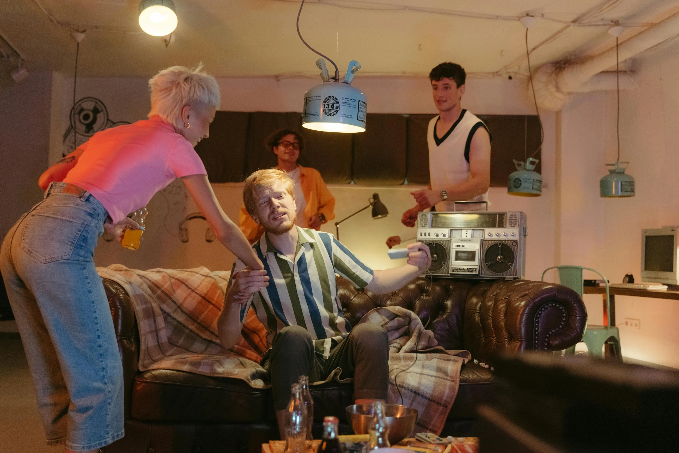 a man sitting on top of a couch next to a woman, an album cover, by Lee Gatch, pexels, cai xukun, bowater charlie and brom gerald, performing a music video, batteries not included