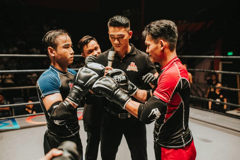 a group of men standing next to each other in a boxing ring, pexels contest winner, jin shan and ross tran, elbow pads, [ theatrical ], mma