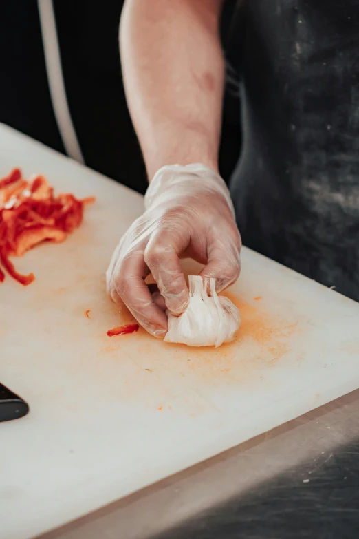 a person preparing food on a cutting board, devil's horns, local foods, premium quality, trending photo