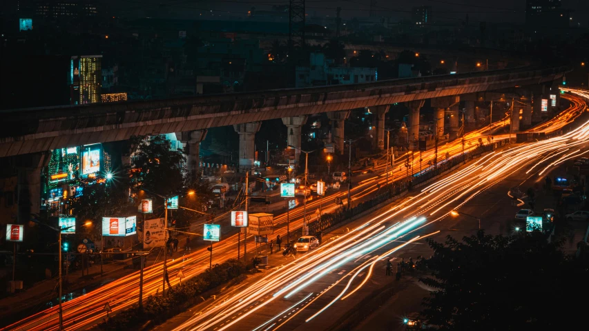 a city street filled with lots of traffic at night, pexels contest winner, beautiful futuristic new delhi, overpass, thumbnail, orange and cyan lighting