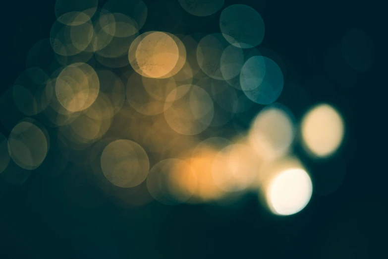 a blurry photo of some lights in the dark, a picture, inspired by Elsa Bleda, unsplash, generative art, gold dappled light, glowing hue of teal, 15081959 21121991 01012000 4k, vintage color