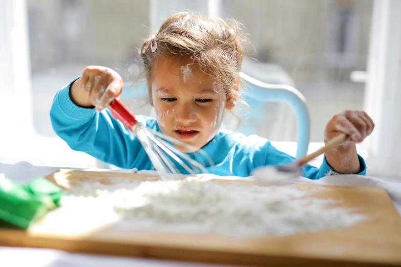 a little girl that is sitting at a table, by Arabella Rankin, pexels contest winner, process art, cooking pizza, rice, square, white