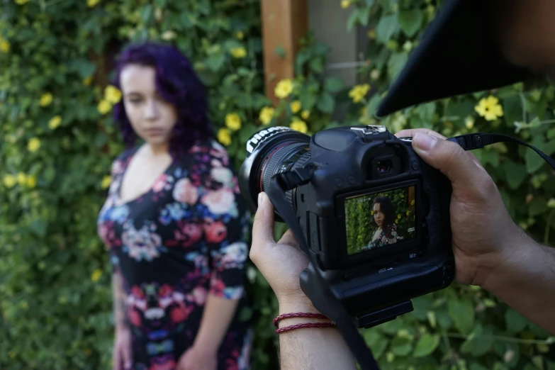 a man taking a picture of a woman with a camera, a portrait, by Winona Nelson, unsplash, taken with canon 5d mk4, menacing, realistic colorful photography, very short depth of field