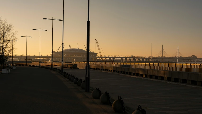 a large long train on a steel track, by Attila Meszlenyi, unsplash contest winner, renaissance, art deco stadium, harbour, late morning, seen from outside