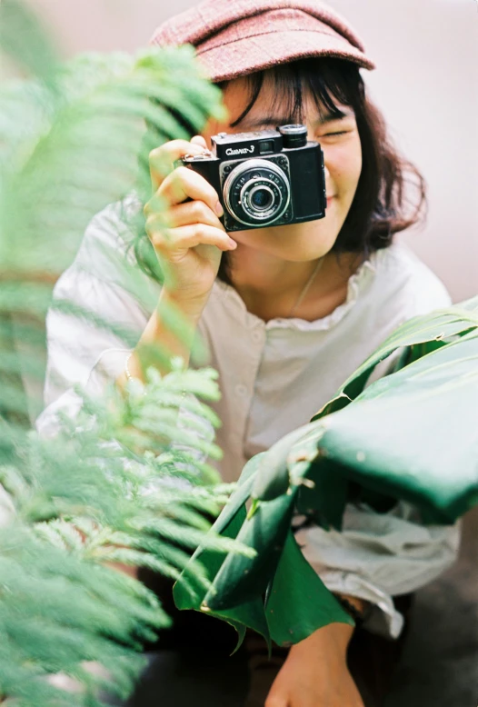 a woman taking a picture with a camera, by Tan Ting-pho, visual art, lush greenery, 35mm of a very cute, having a good time, small