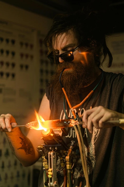 a man is making something with a glass blower, by Lee Loughridge, ned kelly, wearing victorian brass goggles, lighting, weta studio and james jean