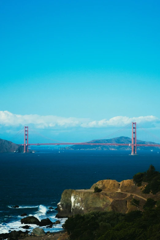 a view of the golden gate bridge from the top of a hill, slide show, blue hues, single, landscape photography