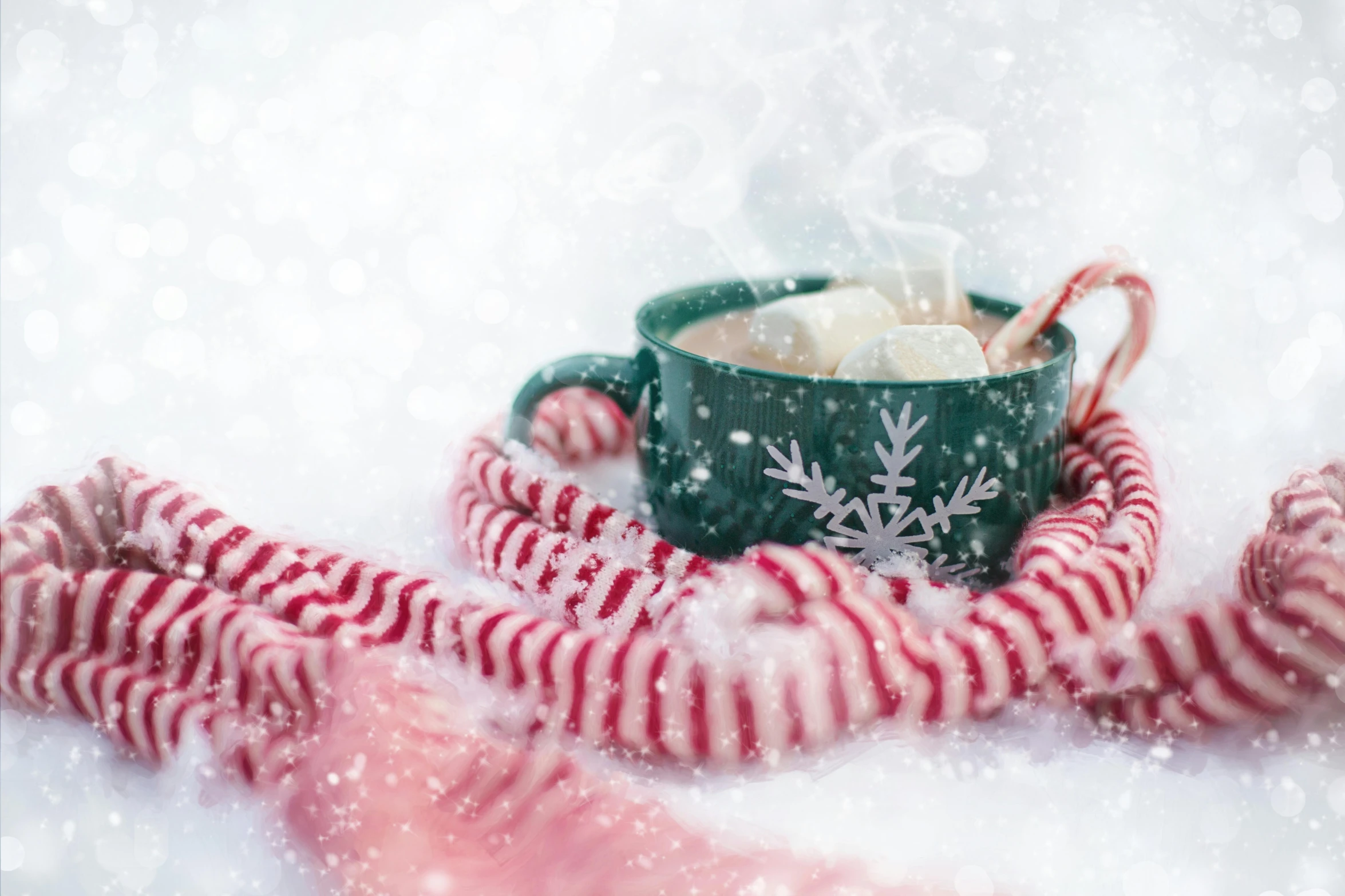 a cup of hot chocolate with marshmallows in the snow, by Emma Andijewska, pexels contest winner, green and pink fabric, red and white stripes, background image, snowflakes