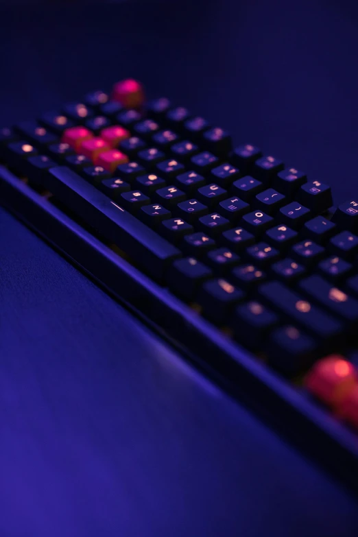 a close up of a keyboard on a table, a digital rendering, reddit, computer art, purple and red, red dot, low - angle shot, dark blue + dark orange