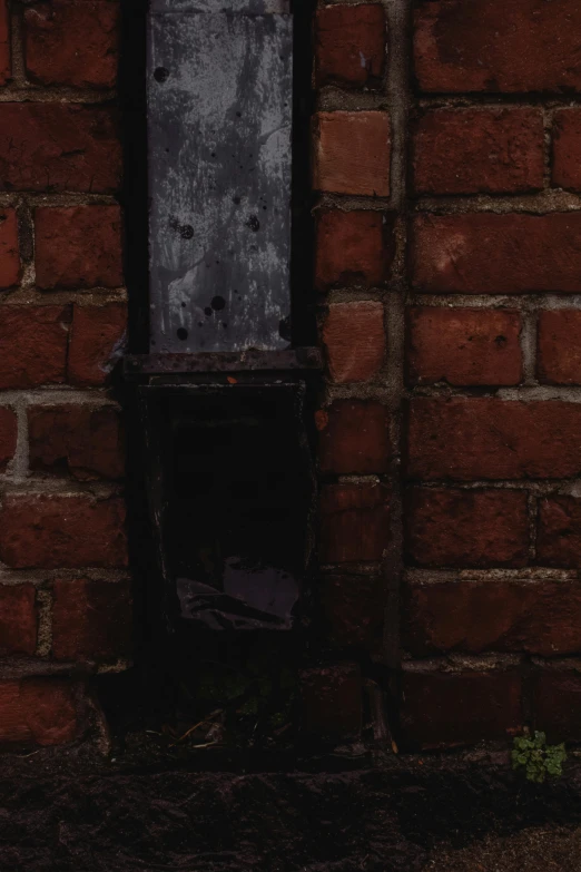 a fire hydrant sitting next to a brick wall, an album cover, letterbox, dark photograph, ((rust)), small