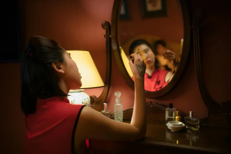 a woman brushing her teeth in front of a mirror, a portrait, inspired by Xie Huan, pexels contest winner, wearing a red cheongsam, hotel room, ( ( theatrical ) ), scene from the film