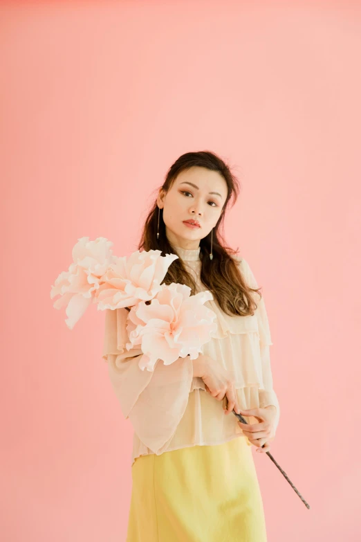 a woman holding a bunch of flowers in front of a pink background, by Ayami Kojima, miranda cosgrove, portrait image, promotional image, candy pastel