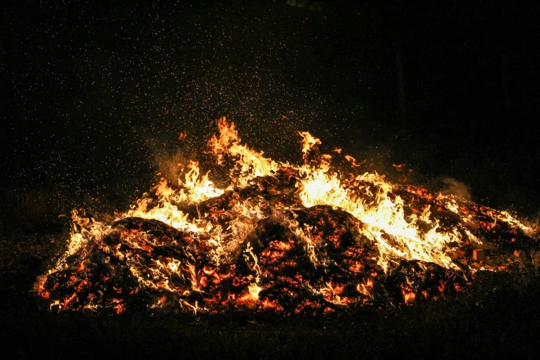 a large pile of fire in the dark, by Rodney Joseph Burn, pixabay, land art, midsummer, avatar image, ignant, historical photo