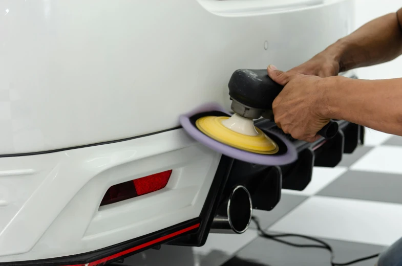 a man polishing a car with a sander, by An Gyeon, pexels contest winner, hyperrealism, round format, 8k ultra detail, japanese, full colored