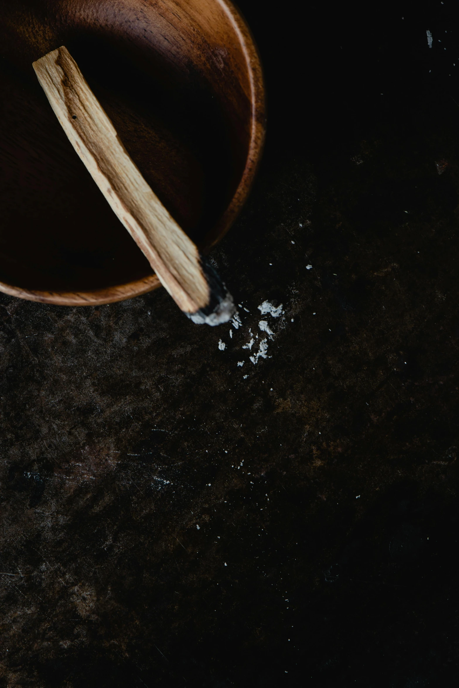 a wooden bowl sitting on top of a table, by Daniel Seghers, trending on unsplash, close up of single sugar crystal, dark kitchen, chalked, spatula