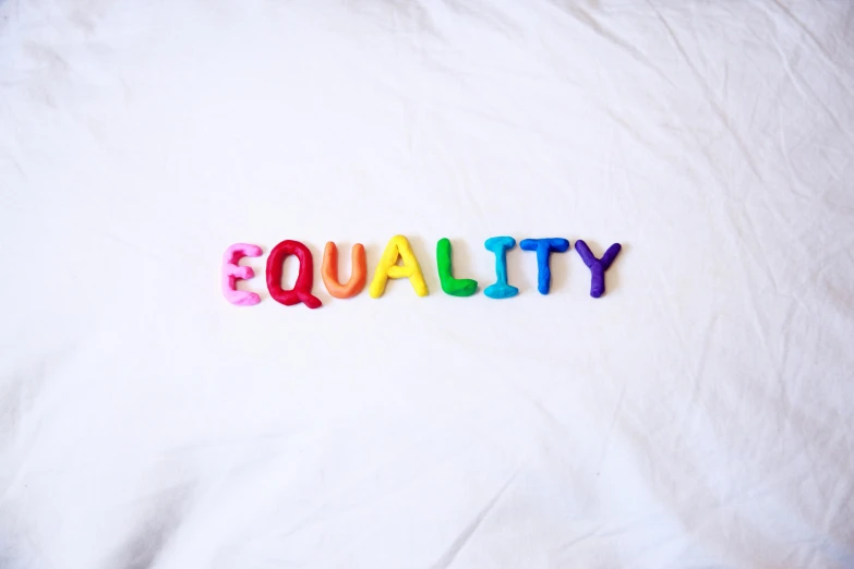 a pillow with the word quality spelled on it, by Arabella Rankin, trending on unsplash, feminist art, multi - coloured, equations, made of rubber, 15081959 21121991 01012000 4k