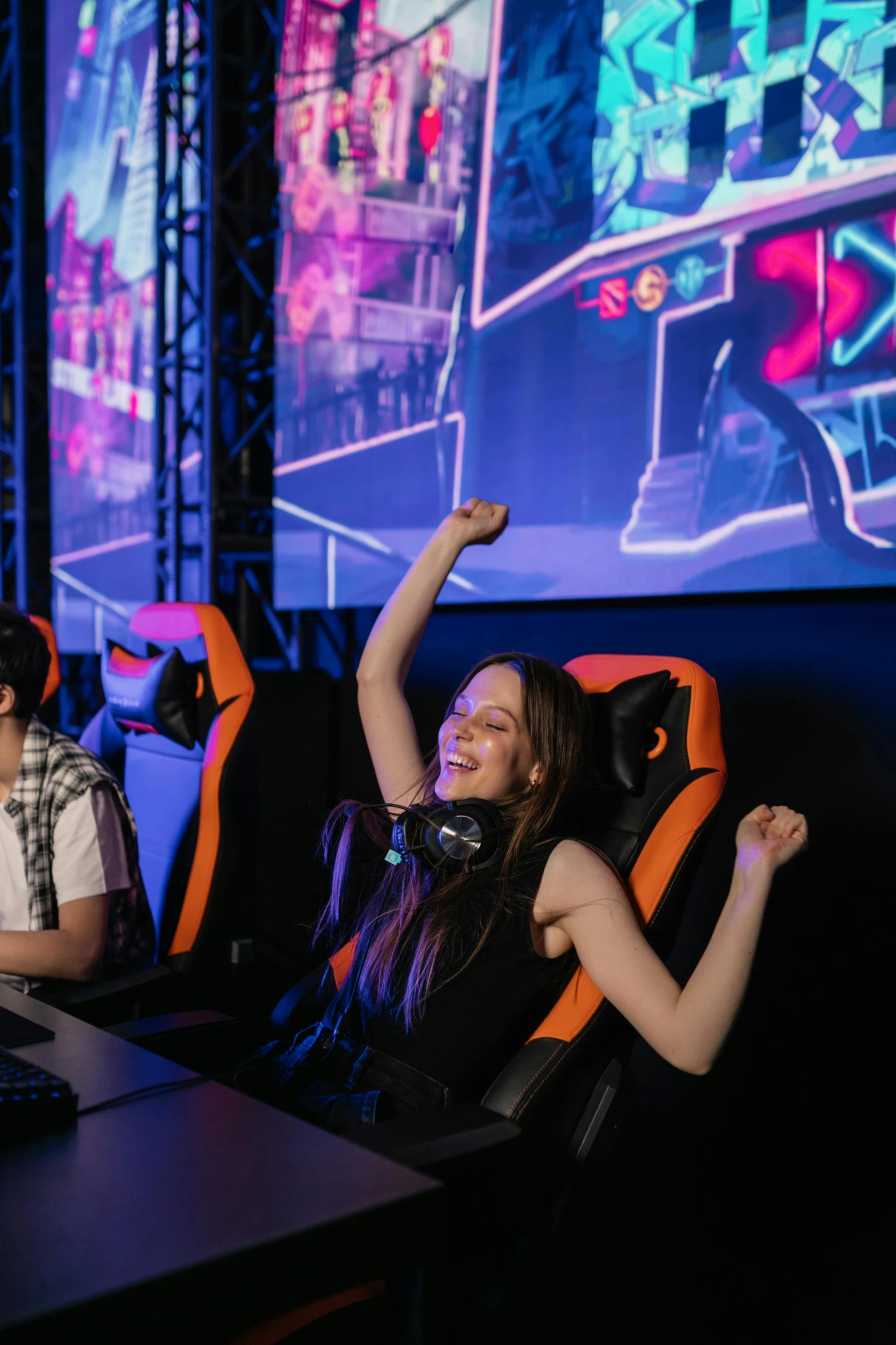 a group of people playing a video game, pink and orange neon lights, gaming chair, screaming into air, penguinz0