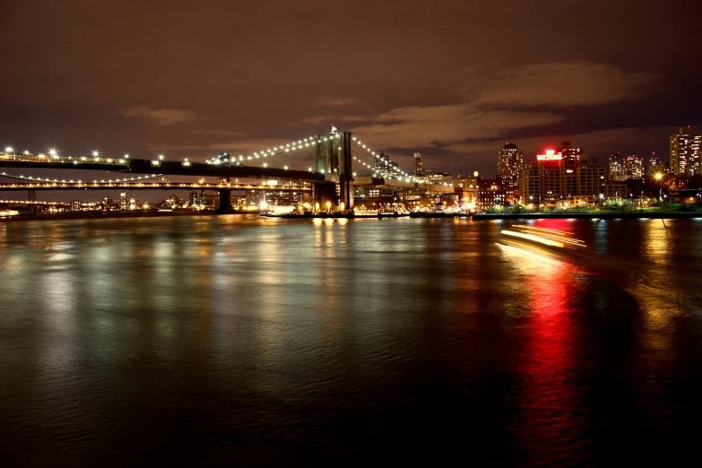 a large body of water with a bridge in the background, inspired by Elsa Bleda, pexels contest winner, hurufiyya, new york city at night, a blond, slide show, in 2 0 1 2