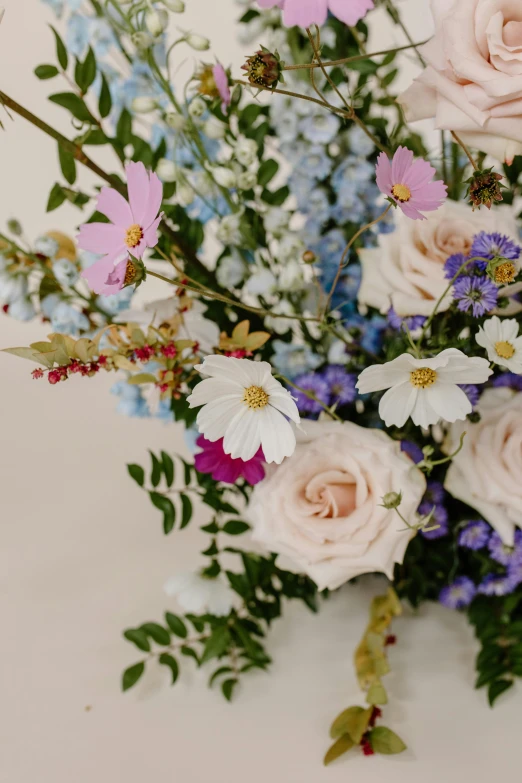 a bouquet of flowers sitting on top of a table, by Elsie Few, trending on unsplash, blue and pink accents, delicate details, cosmos, detail shot