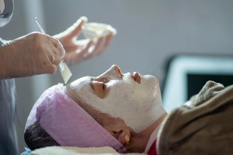 a close up of a person getting a facial mask, by Julian Allen, delightful surroundings, full daylight, cast, manuka