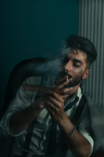 a man sitting in a chair smoking a cigarette, a colorized photo, inspired by Elsa Bleda, pexels contest winner, zayn malik, dapper, headshot profile picture, subject action: smoking a cigar