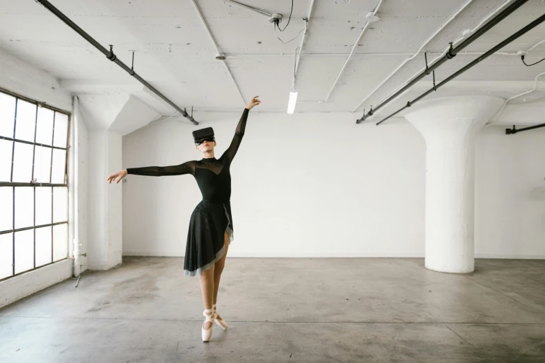 a woman in a black dress is dancing, unsplash contest winner, arabesque, in a white room, wearing black dress and hat, lachlan bailey, dressed as a ballerina