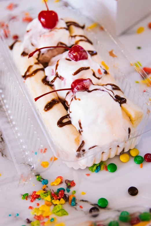 a banana split sitting on top of a table covered in sprinkles, 6 pack, rafeal albuquerque, thumbnail, white